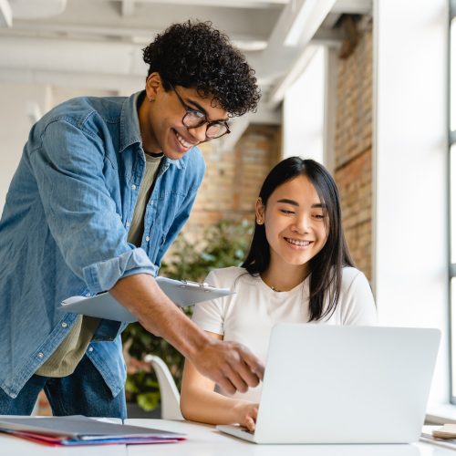 Two young business partners working together in working space